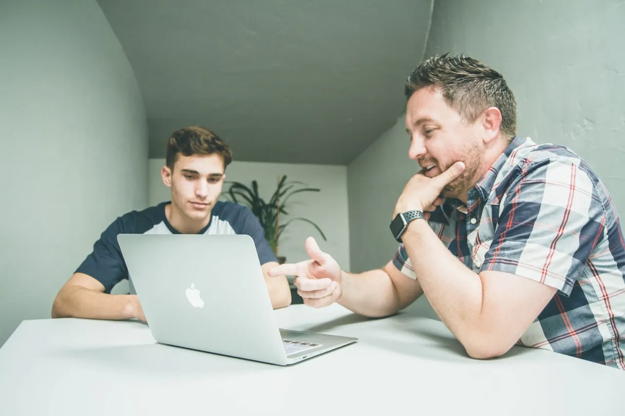 Technology professional demonstrating on a laptop during a mentoring session